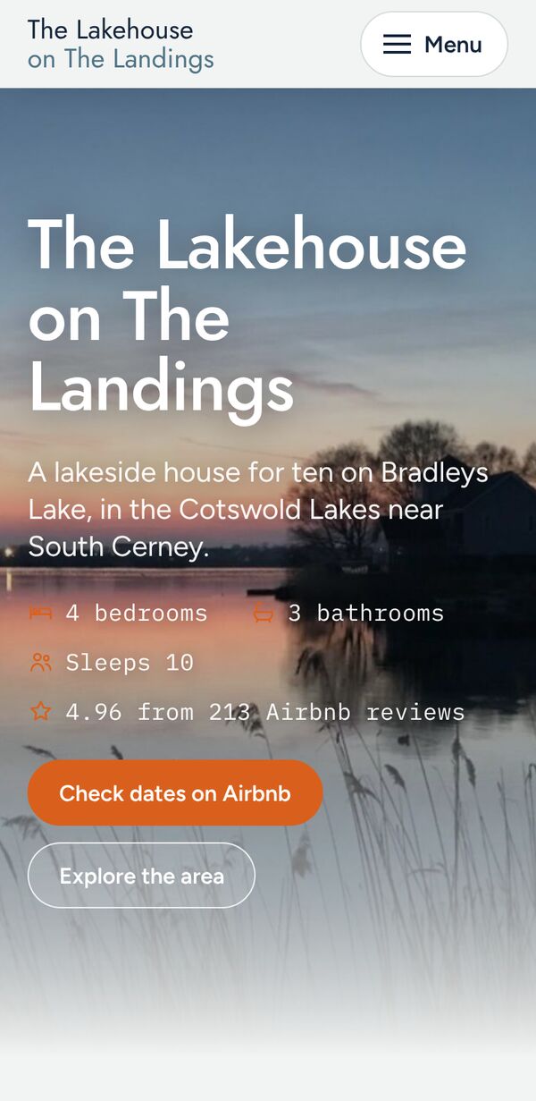The Lakehouse on The Landings home page on a phone, with the house name over a sunset lake photo and a Check dates and book button
